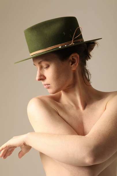 Vertical portrait of confident young woman wearing green hat posing indoor. Mock-up. High quality photo. - Foto, imagen