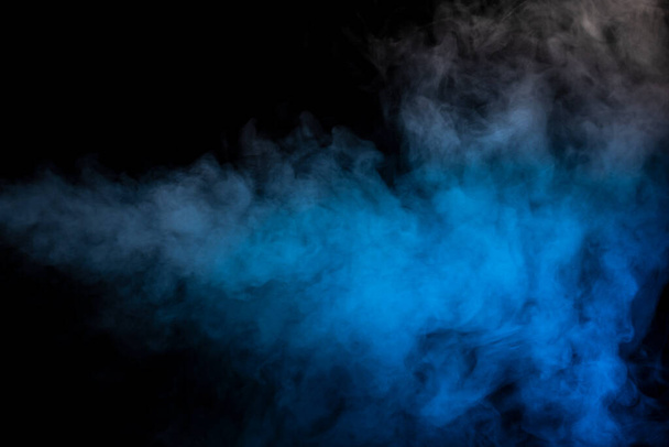 Blue and yellow steam on a black background. Copy space. - Foto, imagen