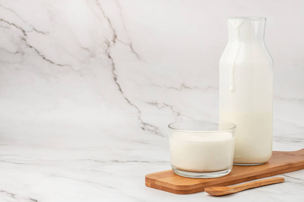 homemade yogurt, kefir, fermented milk on a light background. Healthy, clean eating. Vegan or gluten free diet. - Foto, imagen