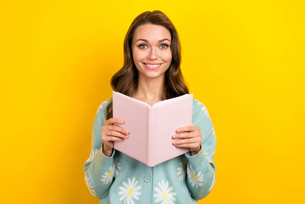 Photo of cute cheerful person toothy smile hands hold opened book isolated on yellow color background. - Foto, immagini