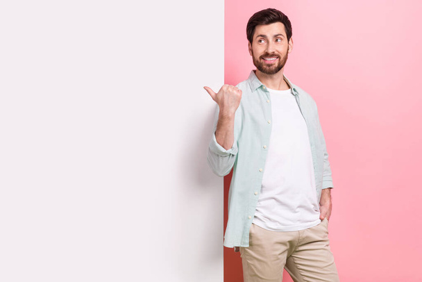 Photo of young funny entrepreneur wear stylish apparel look direct finger empty space banner information isolated on pink color background. - Foto, Bild