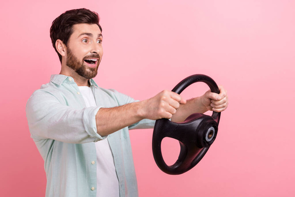 Photo of crazy fast speed drunk driving young man hold steering wheel wear shirt unexpected his skills isolated on pink color background. - Фото, зображення