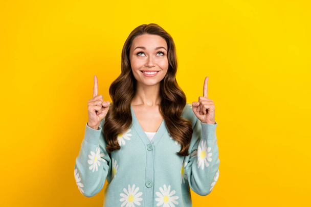 Photo of funky dreamy lady dressed teal cardigan looking pointing two fingers emtpy space isolated yellow color background. - Fotó, kép
