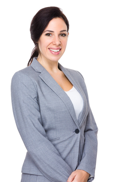 Kaukasische zakenvrouw in grijs pak - Foto, afbeelding