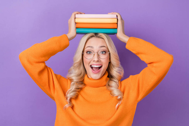 Portrait of ecstatic overjoyed woman elegant hairdo wear pullover turtleneck impressed book shop isolated on violet color background. - Photo, image