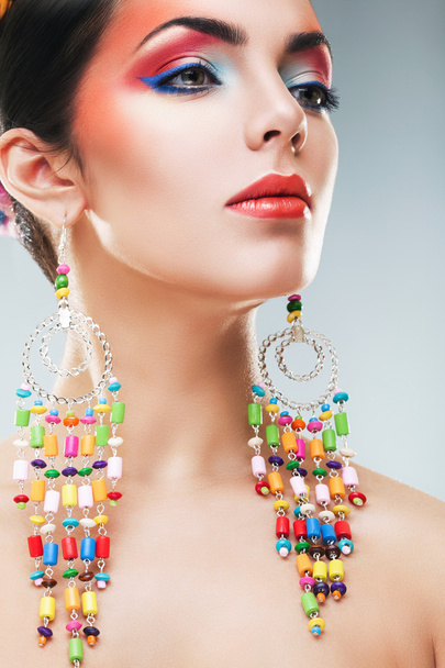 Woman with colourful earrings - Photo, Image