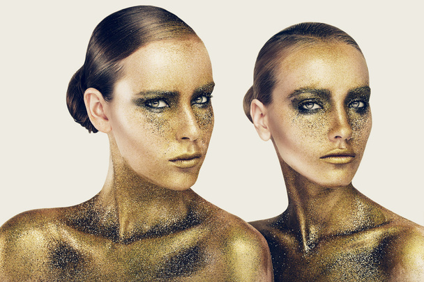 Two pretty women in gold glitters - Fotó, kép