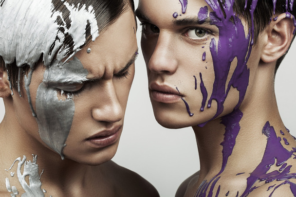 Men with paint on faces - Фото, зображення