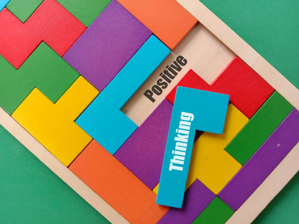 A wooden piece with the text Thinking on colorful puzzle with empty space with Positive text - Foto, immagini