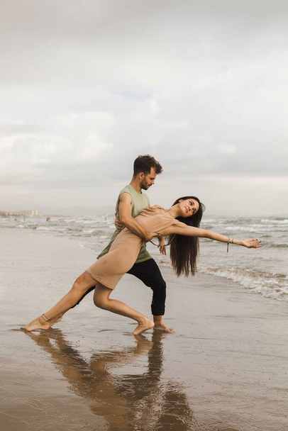 A Caucasian couple doing dance pose in beach - Zdjęcie, obraz