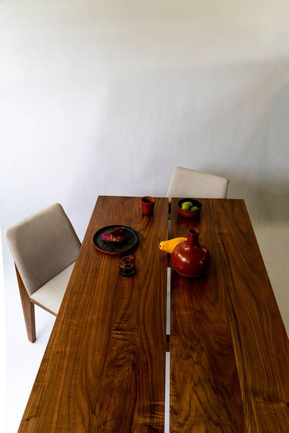 A vertical high angle shot of a modern wooden table with simple decorations - Photo, Image