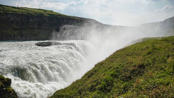 The scenic view of Gullfoss falls and its greenery on a sunny day in Iceland - Фото, изображение