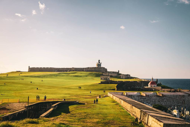 A landscape view of El Morro with visitors in sunlight, San Juan, Puerto Rico - Photo, Image