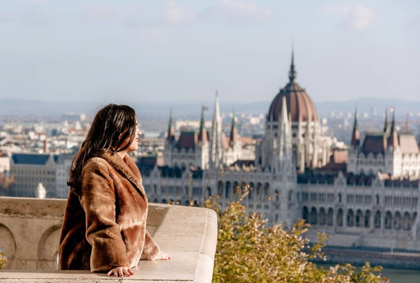 A portrait of a young female on a balcony overlooking Hungarian Parliament, Budapest - Foto, Imagem