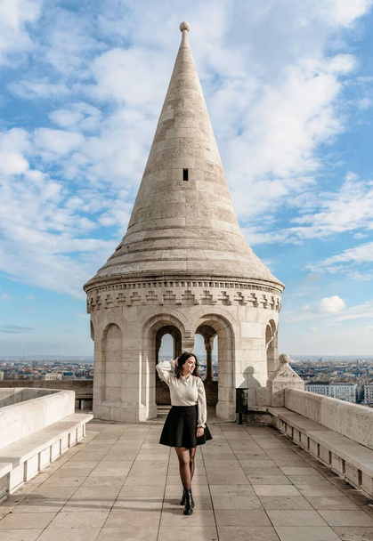 Young female tourist standing in front of tower at Fisherman's bastion in Budapest, Hungary - Photo, image