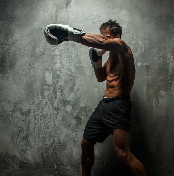Awesome male boxing on grey background. - Фото, зображення