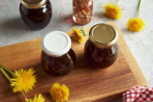 Two jars of dandelion honey - syrup made from fresh flowers in spring - Foto, Imagem