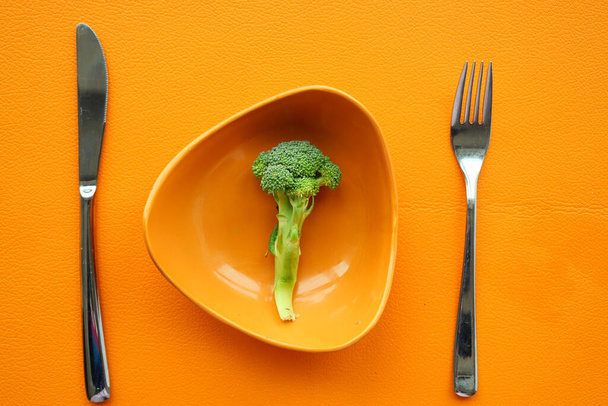 picking raw broccoli with fork , - Photo, Image