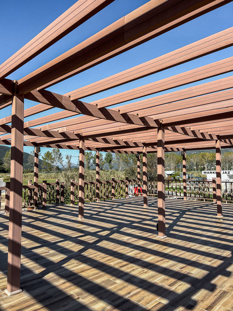 Large wooden pergola with cross beams and terrace. High quality photo - Photo, Image