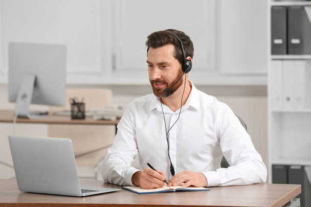 Hotline operator with headset working in office - Foto, Imagem