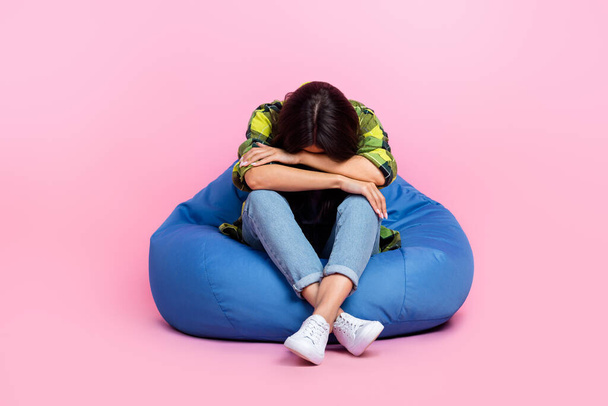 Full length photo of bored depressed woman dressed plaid shirt sitting bean bag sleeping napping isolated pink color background. - 写真・画像
