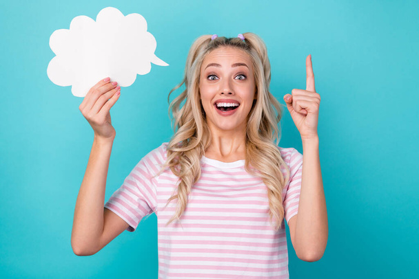 Portrait of pretty excited candid person hold empty space cloud shape card point finger excellent isolated on cyan color background. - 写真・画像