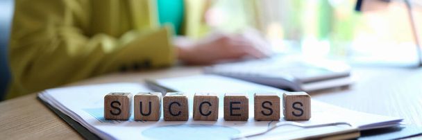 Close-up of success word collected with wooden cubes in row. Goal achievement, targeting, and business concept - Foto, Imagen