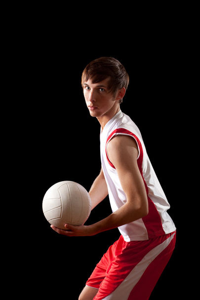 Male volleyball player. Studio shot over black. - Fotó, kép