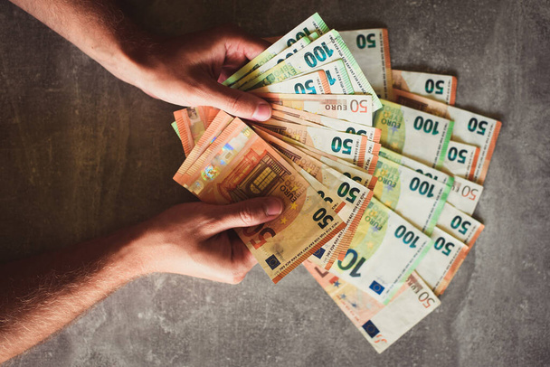 Euro banknotes in man's hands - Fotoğraf, Görsel
