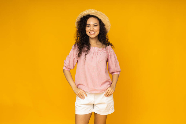 Young woman in casual summer wearing on yellow background - 写真・画像