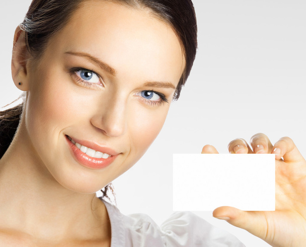 Businesswoman showing business or plastic credit card, on grey - Zdjęcie, obraz