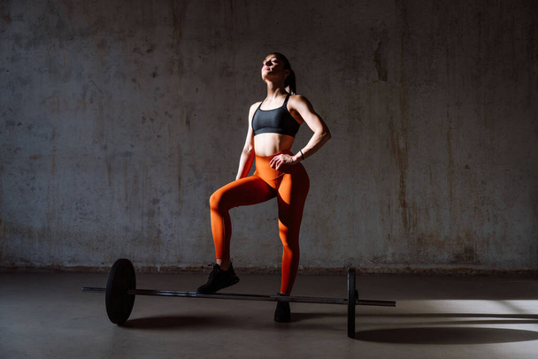 Young female athlete training in a gym using sport equipment. Fit woman working out . Concept about fitness, wellness and sport preparation. - Fotoğraf, Görsel