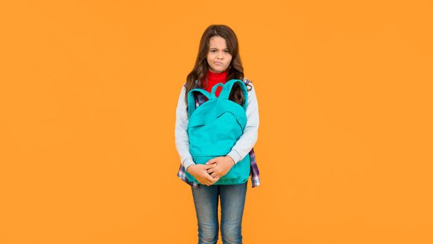 knowledge day. concept of education. kid in casual clothes on yellow background. september 1. happy childhood. child with school bag. sad teen girl carry backpack. back to school. - Foto, immagini