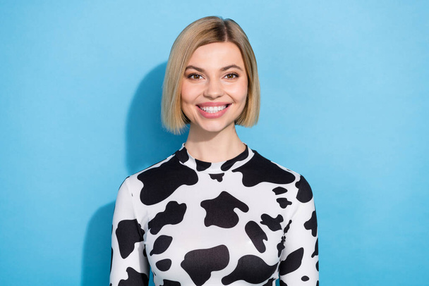 Photo of cheerful adorable lady wear dalmatian print clothes smiling isolated blue color background. - Foto, Bild