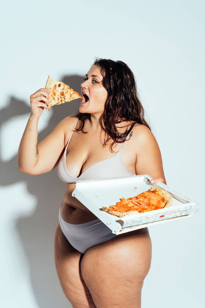 Plus size woman posing in studio in lingerie. Model on white background. Hard light studio shot - Fotografie, Obrázek