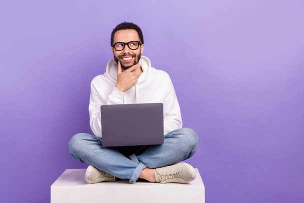 Full body size cadre of deciding man young touch beard use netbook look mockup planning his weekend isolated on purple color background. - 写真・画像