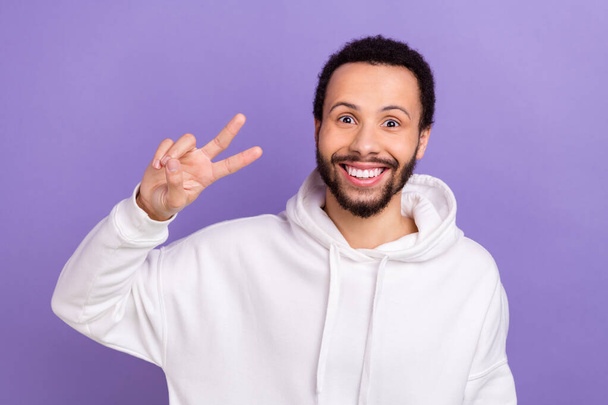 Portrait of positive satisfied person beaming smile arm fingers show v-sign isolated on purple color background. - Zdjęcie, obraz
