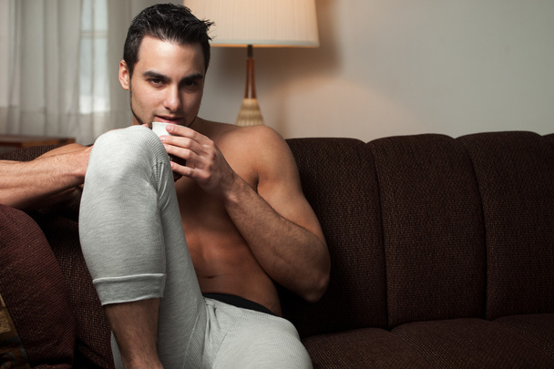Attractive man relaxing at home in long underwear. - Photo, image