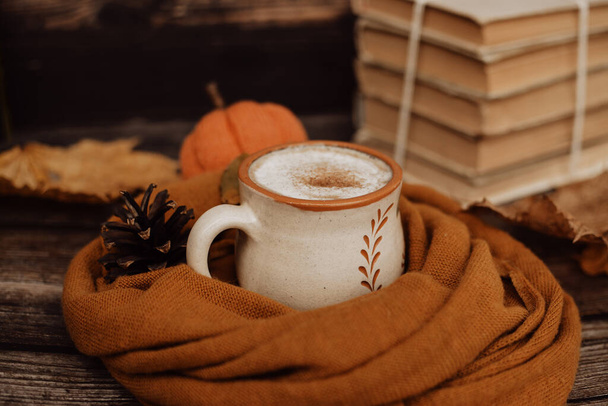 Hot spicy coffee and pile of old books on wooden background - Foto, Imagen