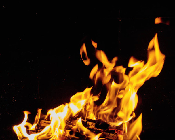 glowing orange flames of fire. symbol of heat and energy - Fotó, kép