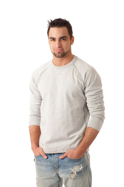 Young man in jeans and sweater. Studio shot over white. - Zdjęcie, obraz