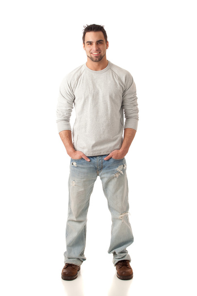Young man in jeans and sweater. Studio shot over white. - Photo, image