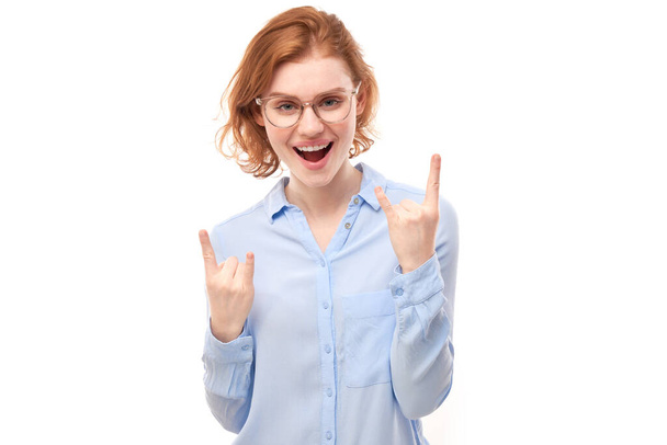 Portrait of young redhead woman showing rock and roll gesture with fingers isolated on white background - Φωτογραφία, εικόνα