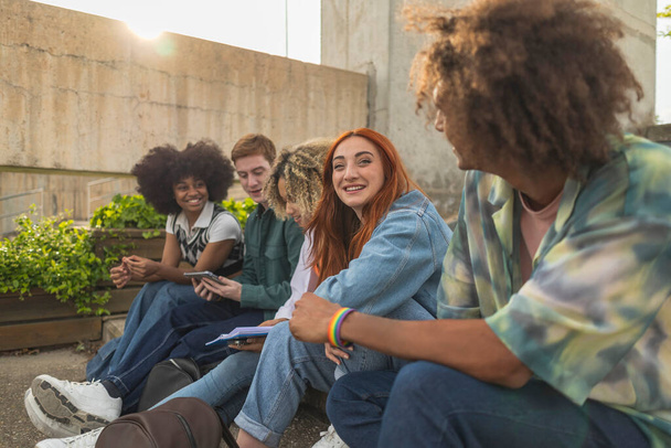 Group of friends college students sitting together multi-ethnic people of different cultures, lifestyle - focus on redhead woman - - Photo, Image