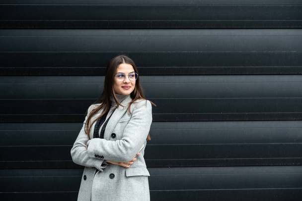 Portrait of a young successful businesswoman, sales manager, boss and foreman standing in front of an office building. Business person leader and expert in global business and telecommunications - Fotoğraf, Görsel