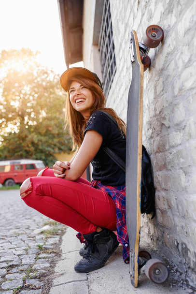 Portrait of cute urban girl with longboard outdoors - Zdjęcie, obraz