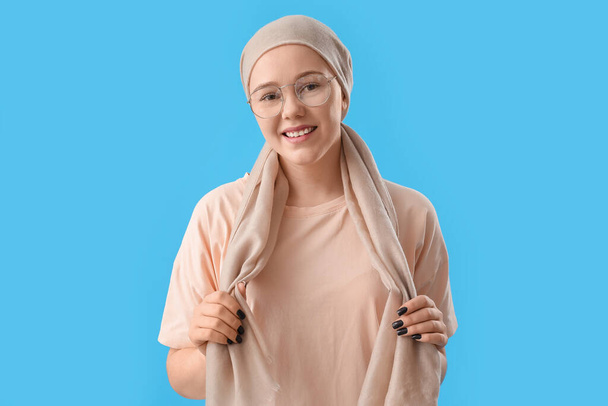 Teenage girl after chemotherapy on blue background - Photo, Image
