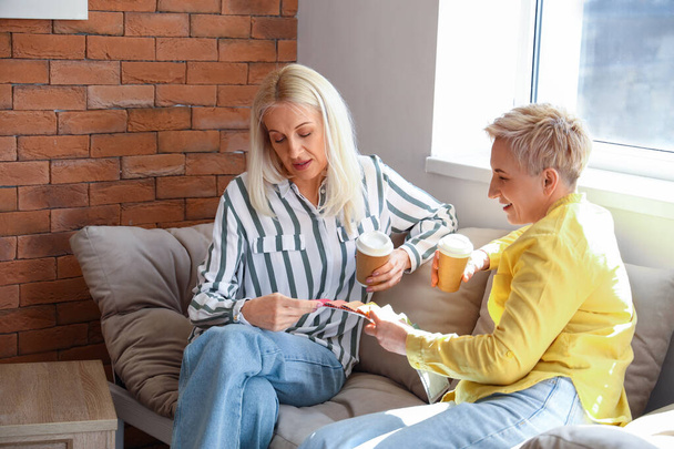 Mature women choosing color of fabric at home - Foto, Bild
