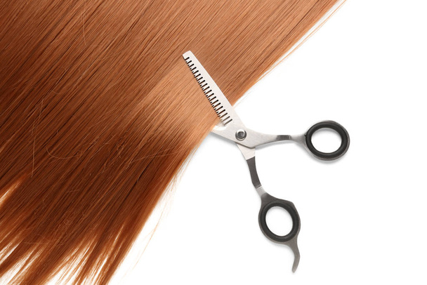 Ginger hair with scissors on white background - Foto, imagen
