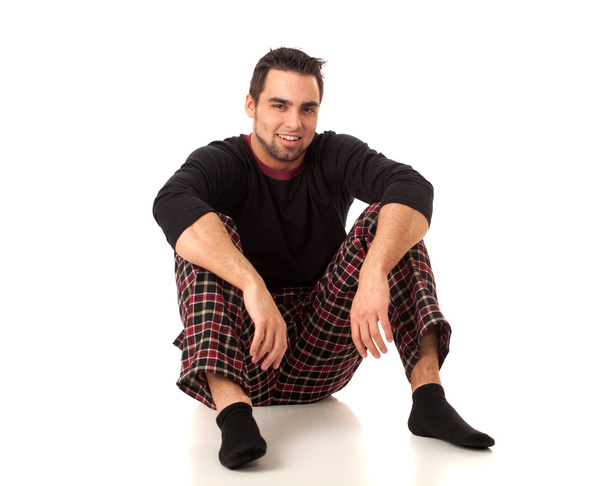 Attractive man in pajamas. Studio shot over white. - Foto, imagen